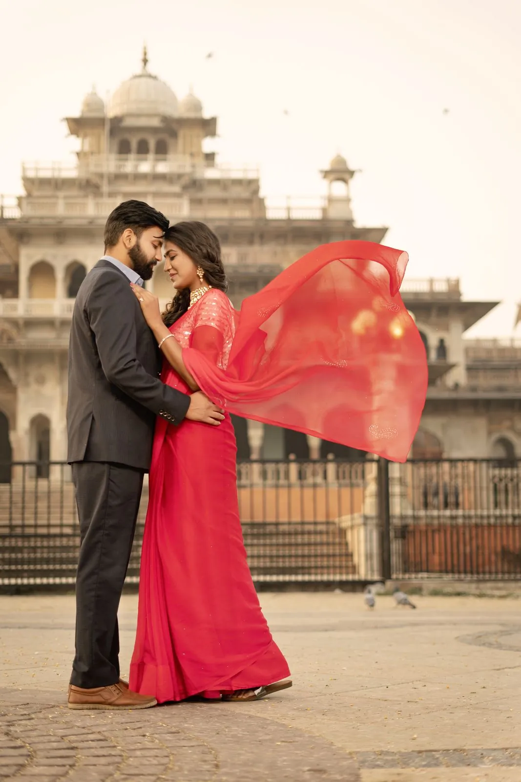 Couple in front of Albert Hall Museum in Jaipur with a red dupatta flying in the wind