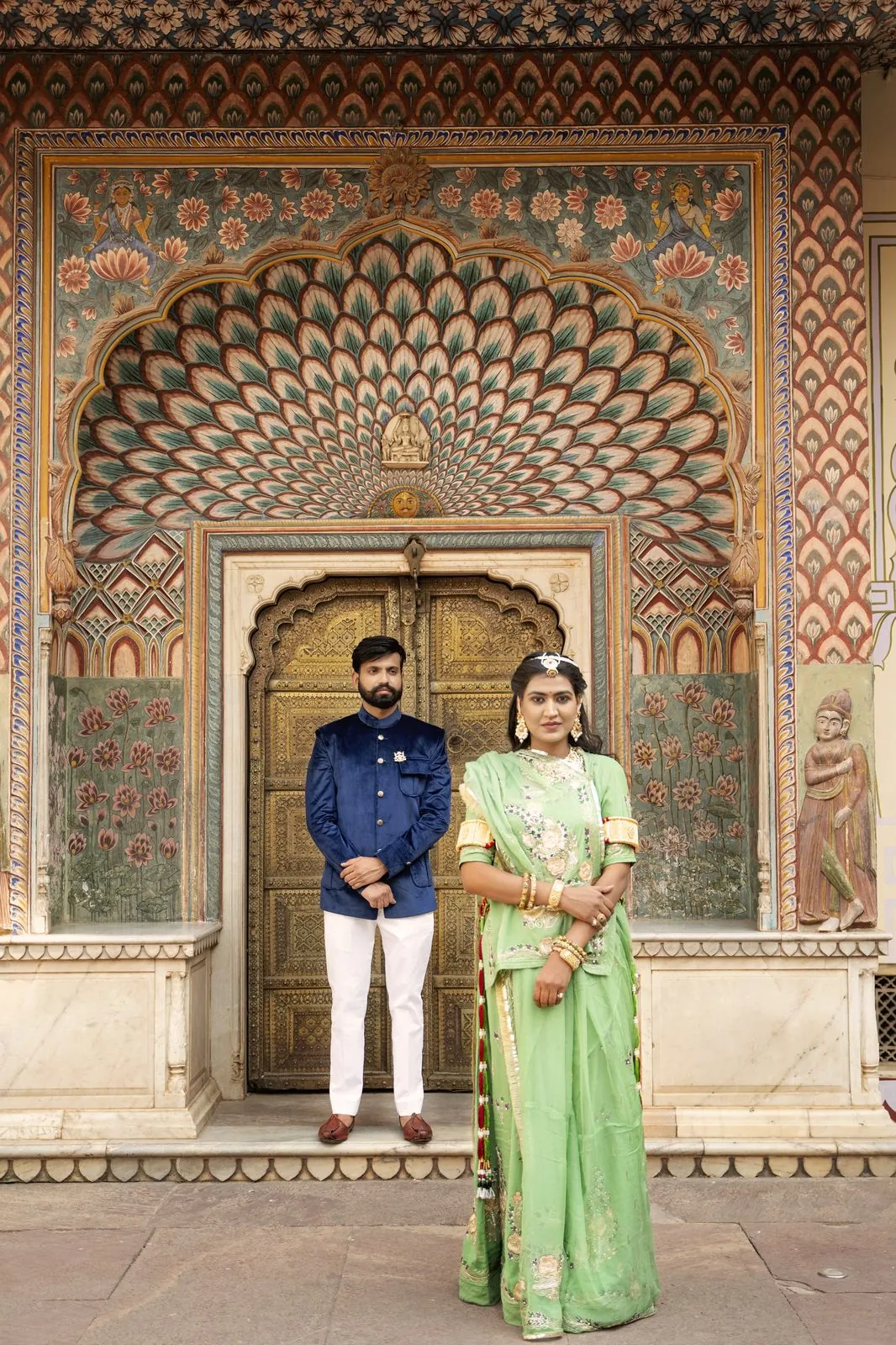 Couple standing in front of the Peacock Gate at City Palace, Jaipur