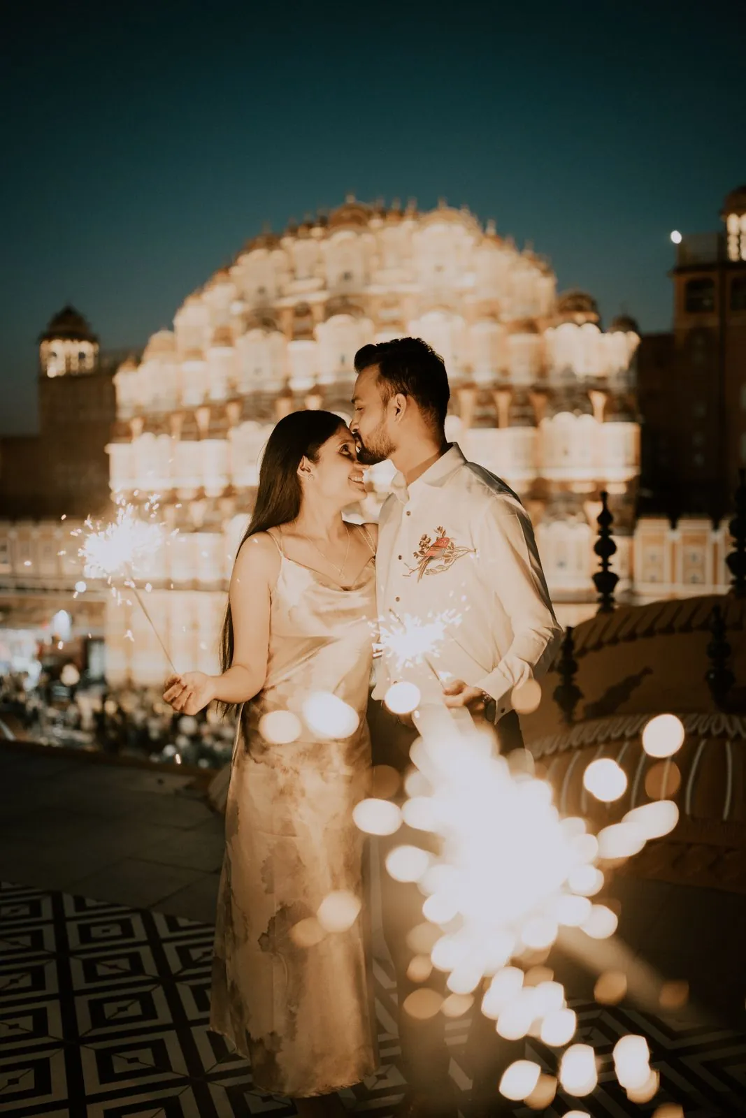 Couple with sparklers at night in front of Hawa Mahal